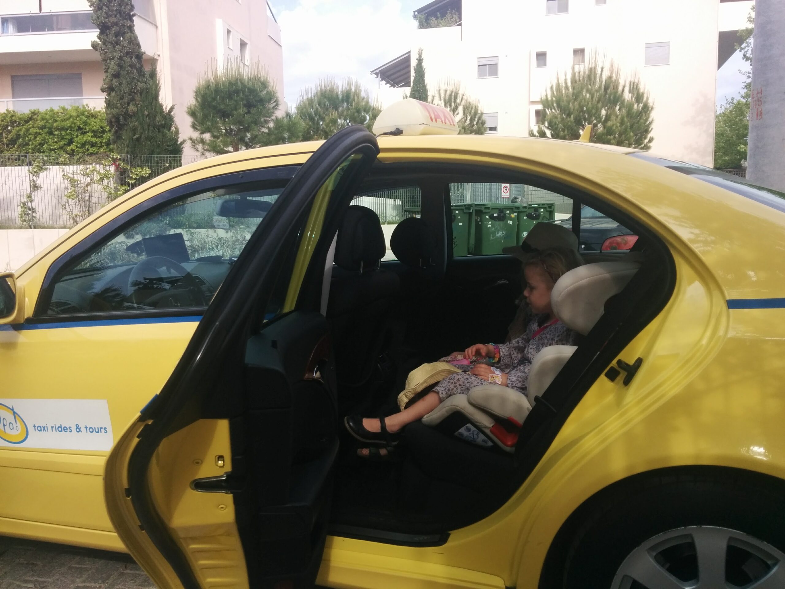 Top things to do in Athens, Greece with children 108 Stefania safe in a car seat in a pre booked transfer taxi