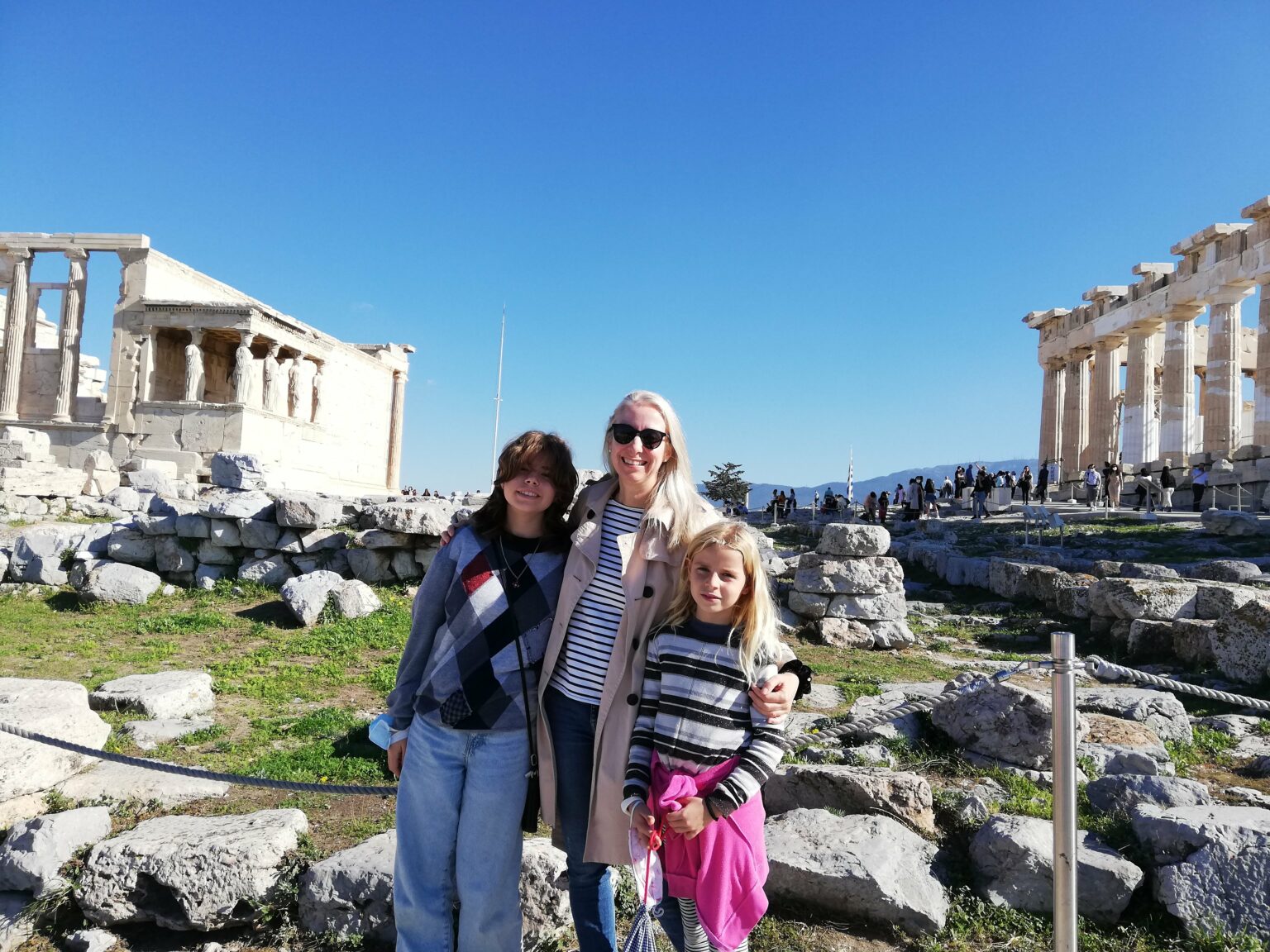 Expert family travel blogger Celeste with her children at the Acropolis hill