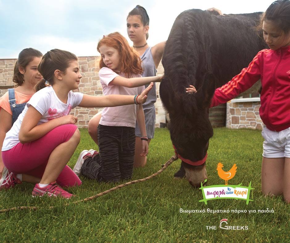 Top things to do in Athens, Greece with children 105 children petting a horse at the mia fora kai ena kairo theme park in greece