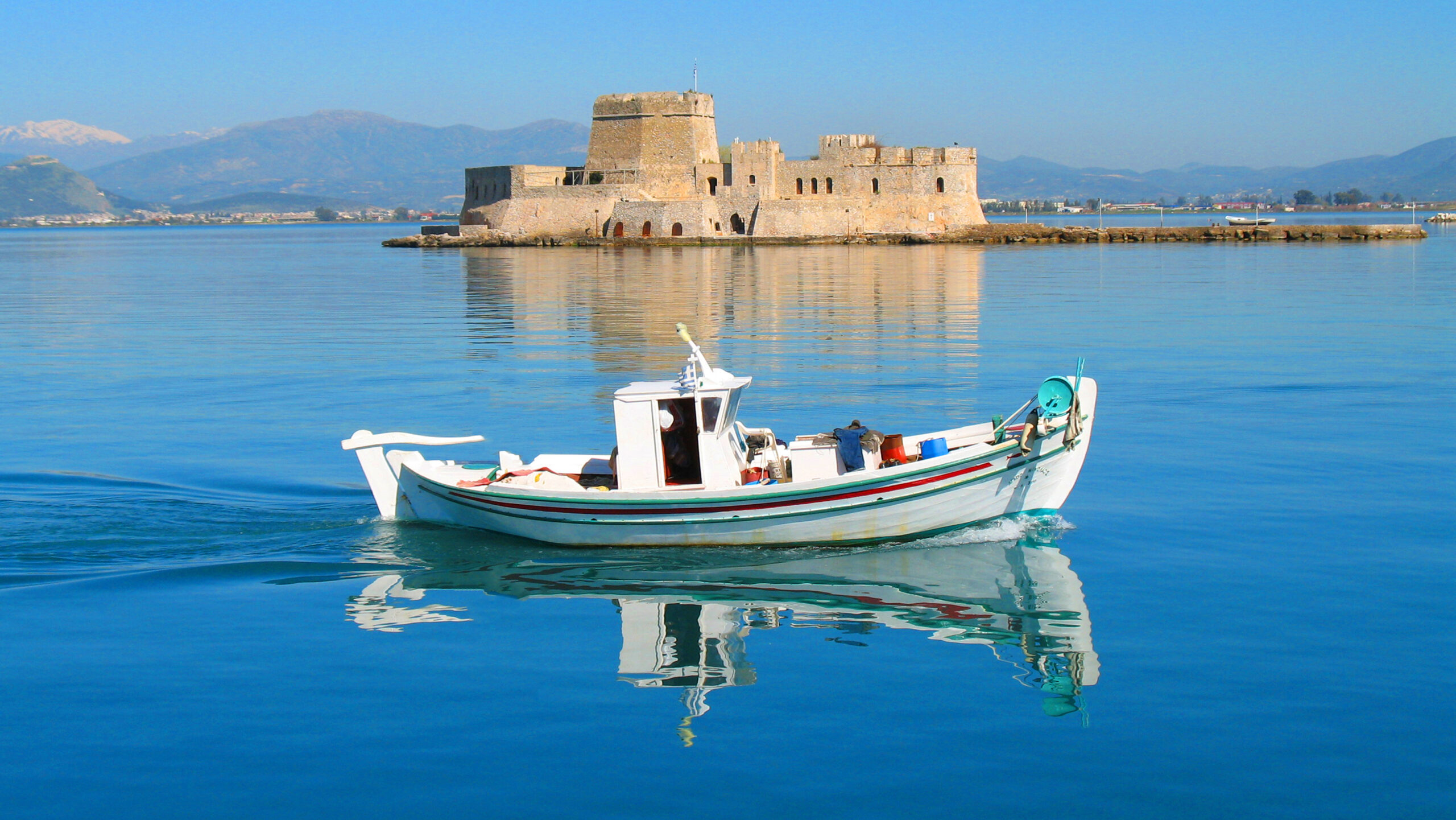Bourtzi fortress traditional fishing boat Nafplio sh scaled