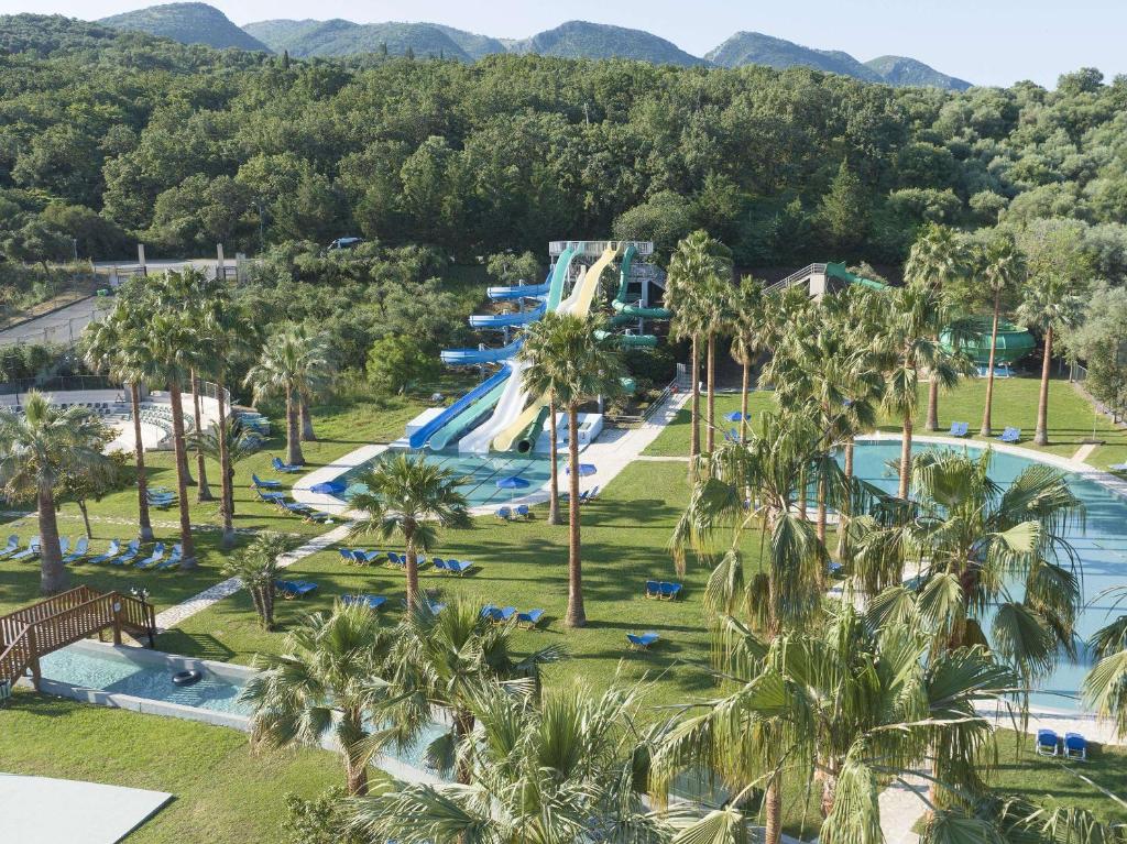 hotel with waterpark water slide green and grass in Corfu Grecotel Lux ME