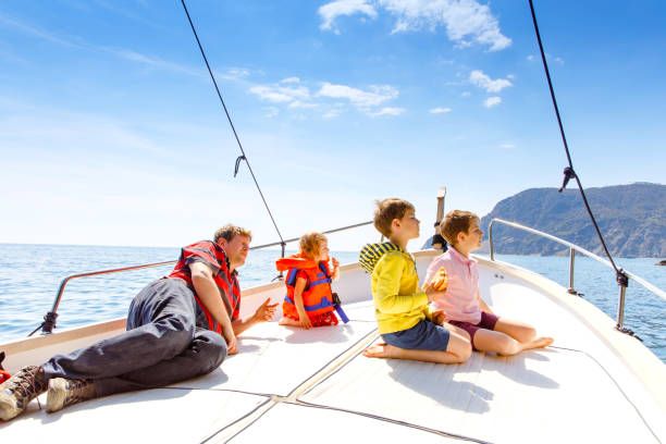 family sailing in Greece with children looking at the horizon without AI travel tools