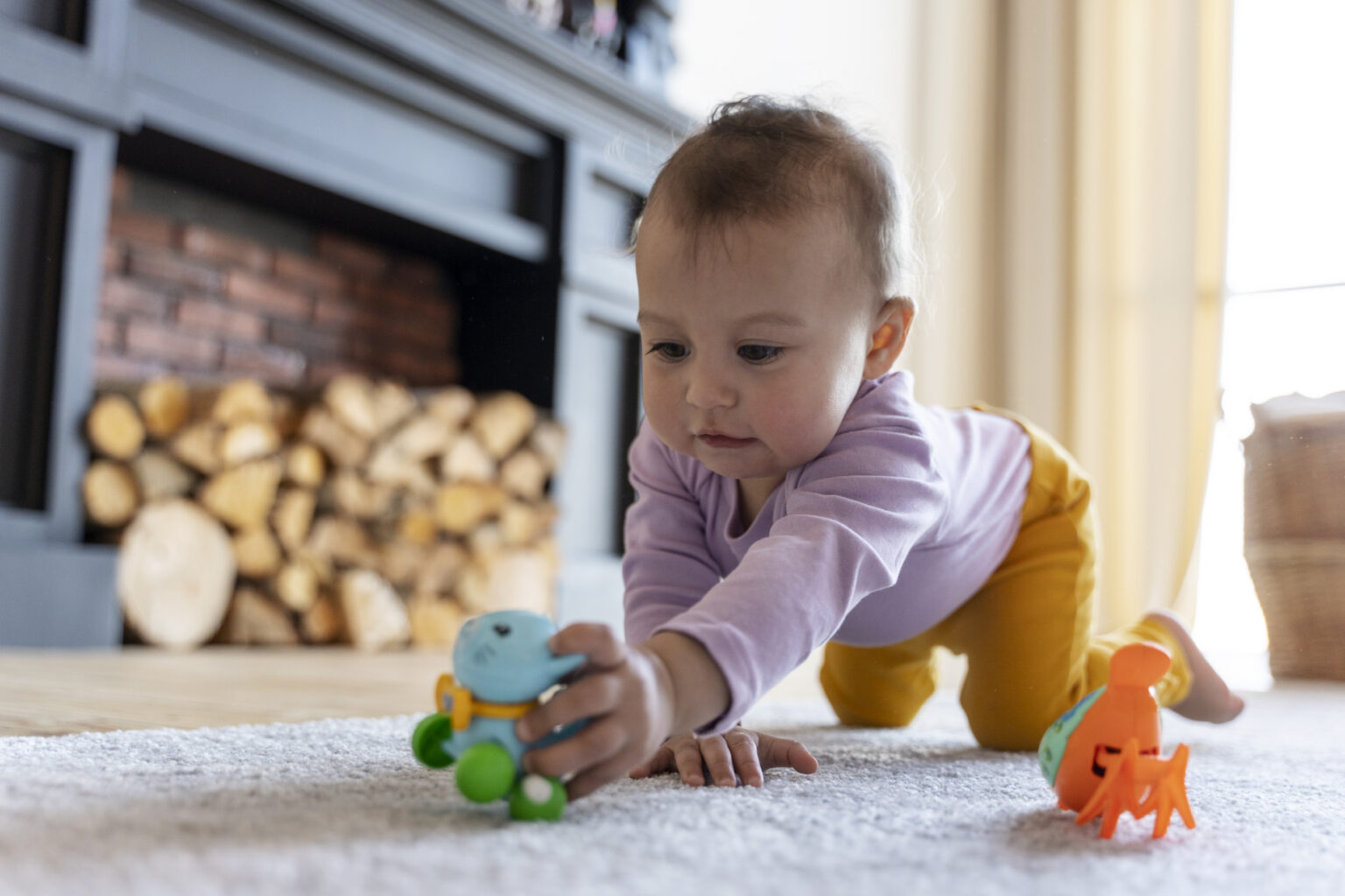 adorable baby playing with toy home floor